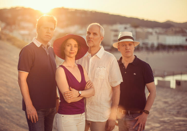 The Casals Quartet posing together as the golden Spanish sun sets in the background 