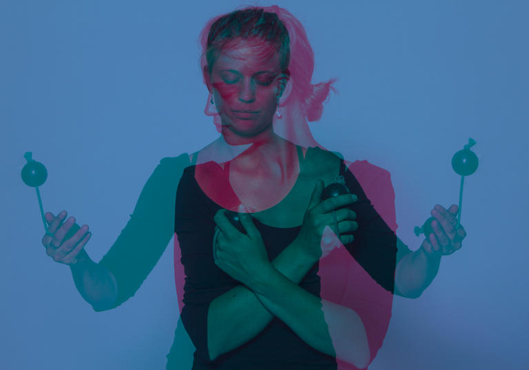 An overlaid image of Vanessa Porter with her drumming sticks