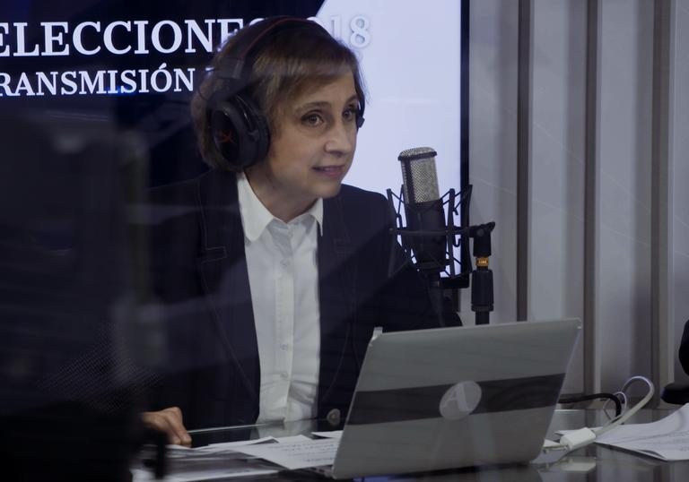 A woman on-air in a radio studio