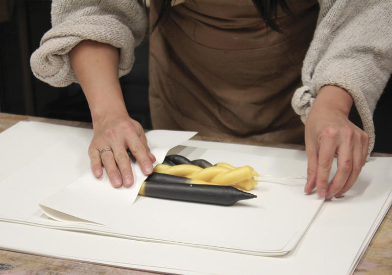 Woman sculpting beewax candle 