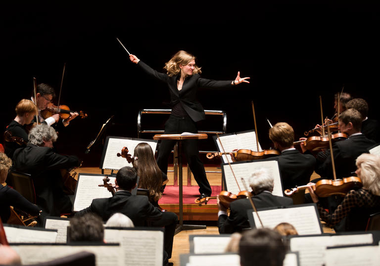 An image of Migra Gražintė-Tyla conducting the City of Birmingham Symphony Orchestra with great vigour