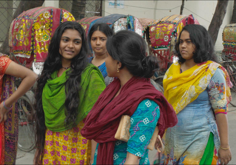group of Bangladeshi women walk down the street 