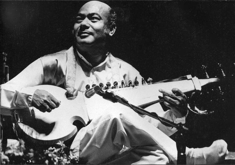 Ustad Ali Akbar Khan performing crossed-legged with his sarod