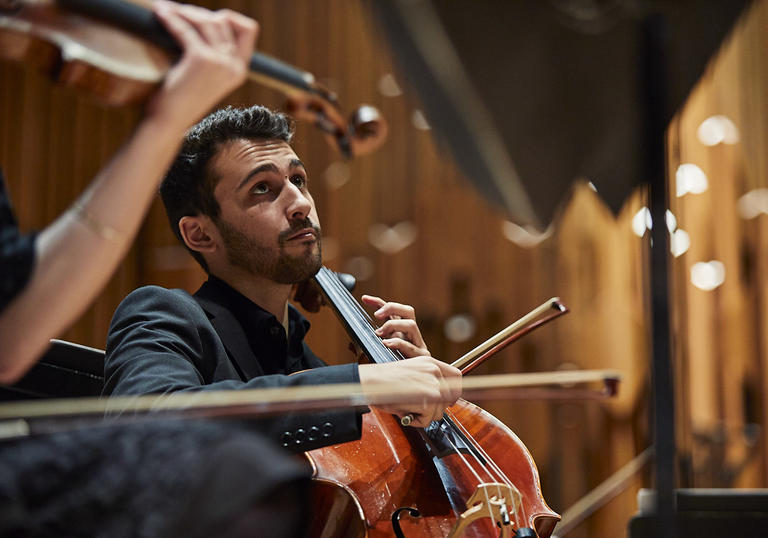 Guildhall Symphony Orchestra cellist on stage