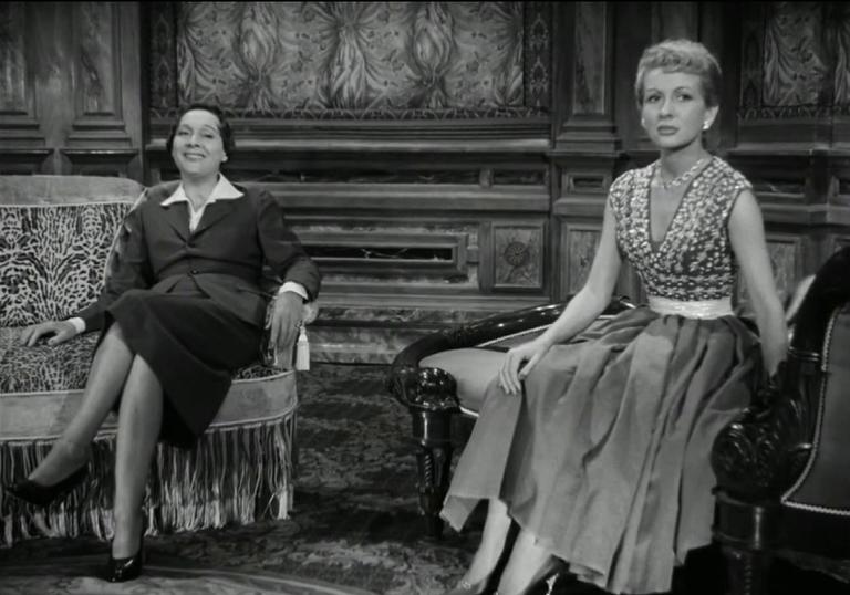 two women sitting in a lounge-like room