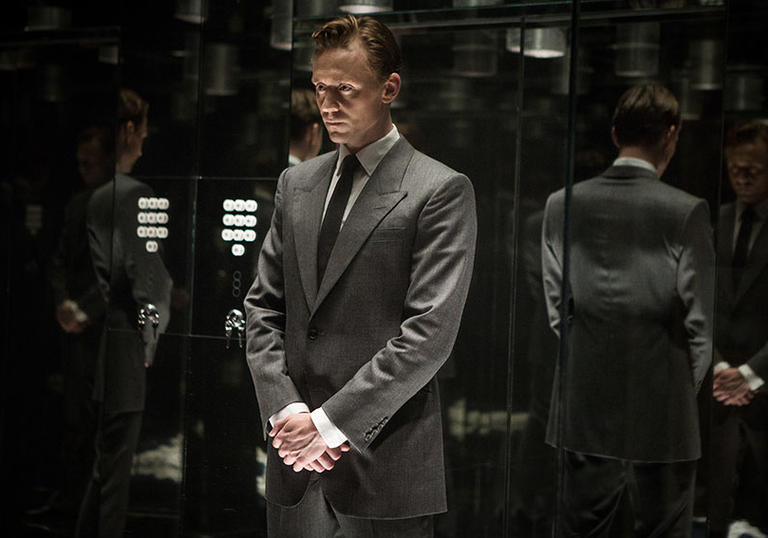 tom hiddleston standing in a room full of mirrors