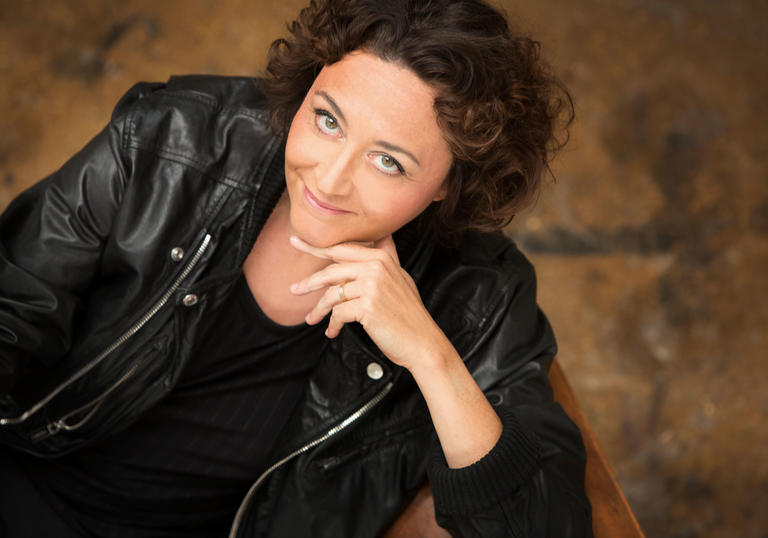 Nathalie Stutzmann smiling at camera which hand under chin