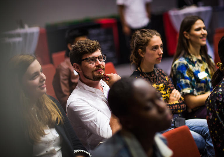 Group of young people sitting in a theatre