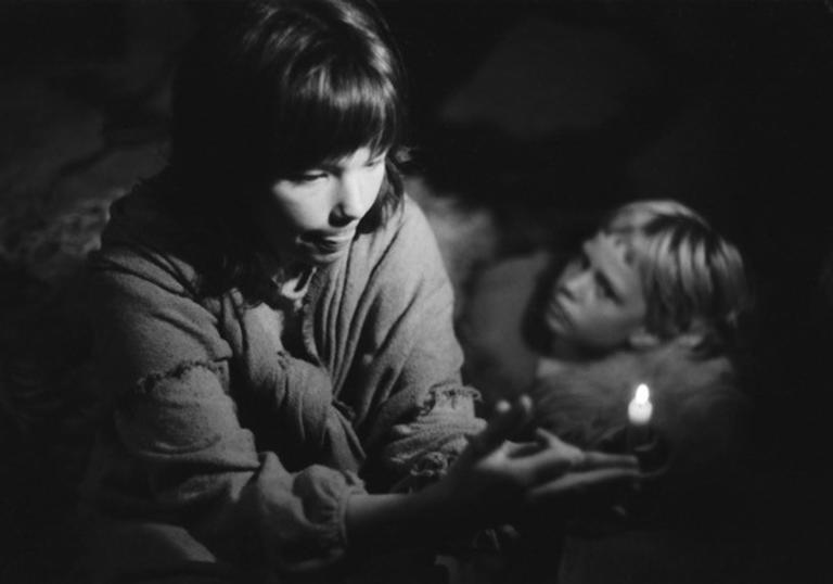 black and white photo of bjork making shadow puppets