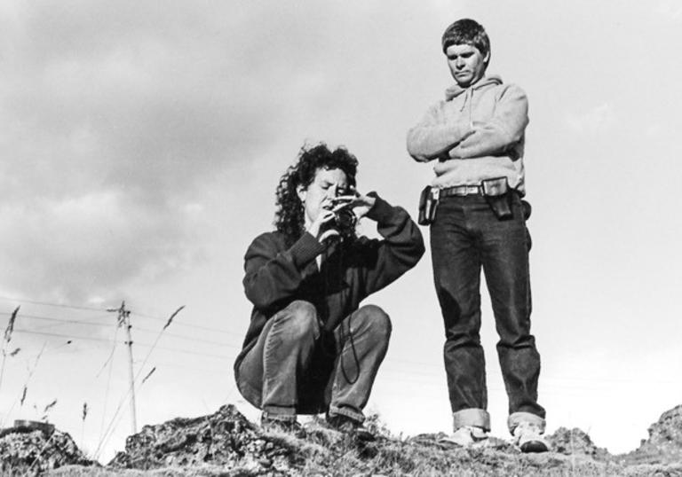 black and white photo of nietchka adjusting a director's viewfinder to preview a shot composition