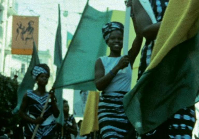 A woman walks as part of a parade in a still image from The Pan-African Festival of Algiers