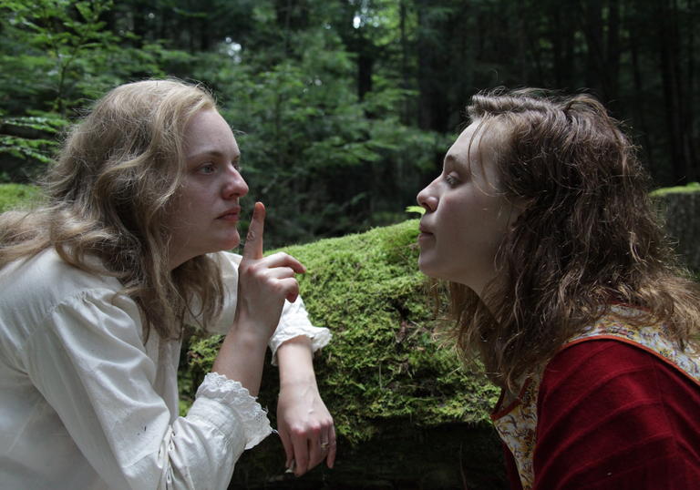 elisabeth moss as shirley jackson in a forest telling Odessa Young to shush