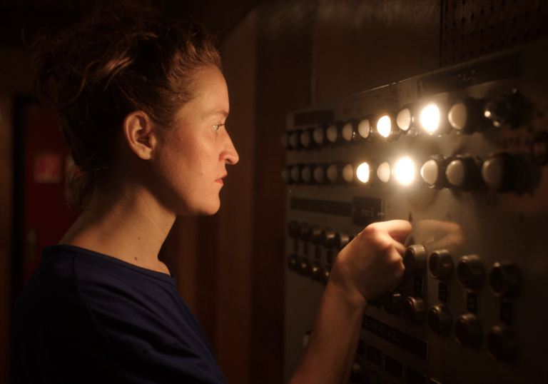 A woman operates a switchboard in The Sound is Innocent