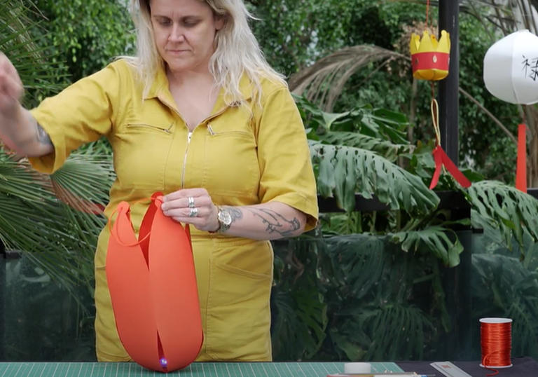 Woman in conservatory making a lantern