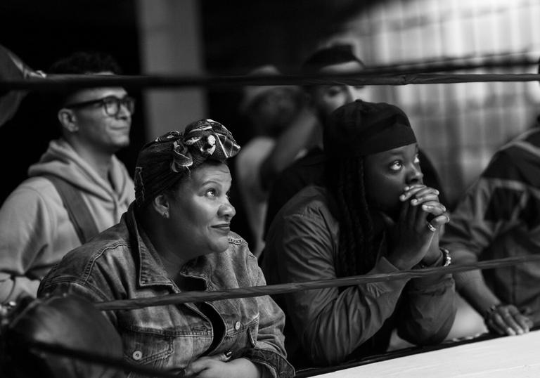 Radha Blank sits at the side of a boxing ring