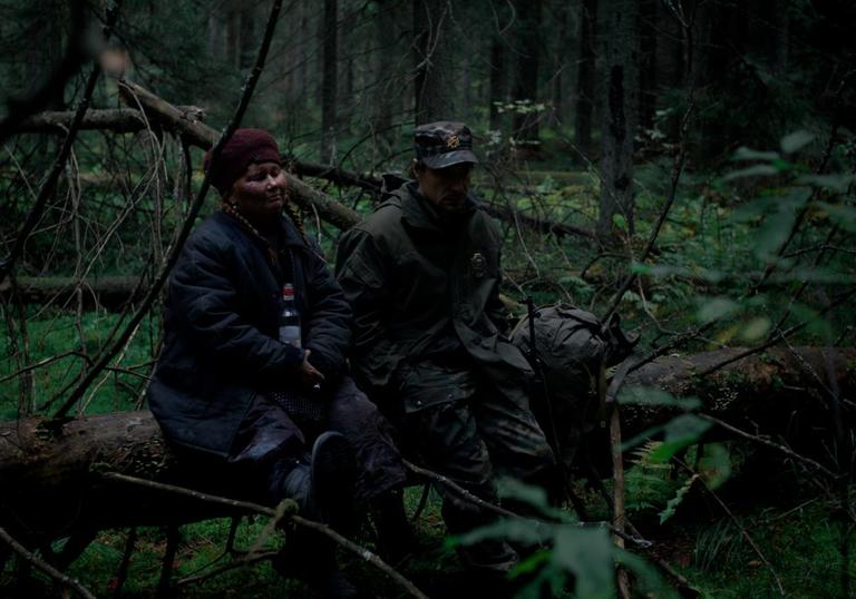 photo of two people in the bushes