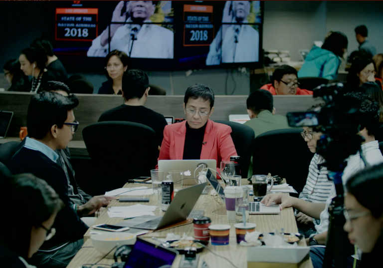 a group of people sit around a conference table