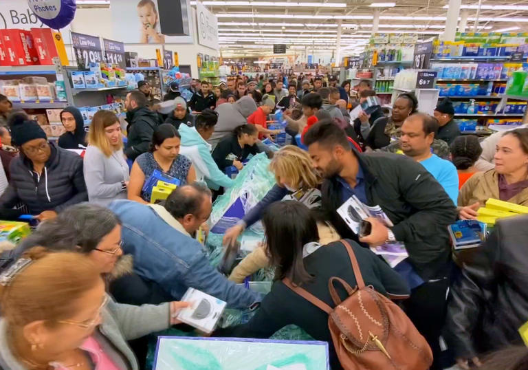people fight to get the products they want in a supermarket