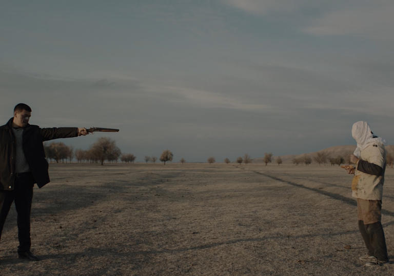 a man in black with a gun