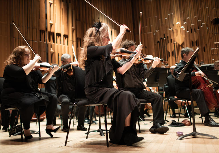 Some of the member of Britten Sinfonia on the Barbican stage