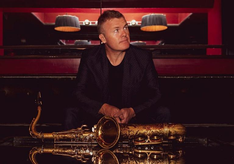 Iain Ballamy with saxophone on table in front of him
