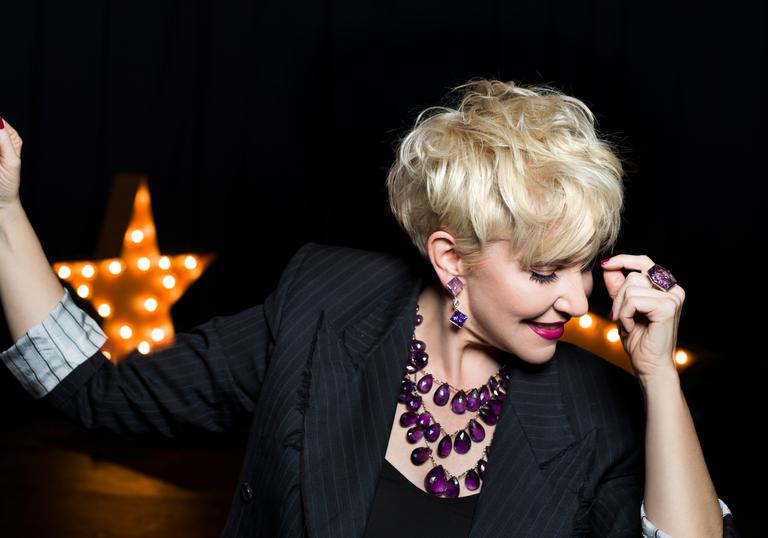 Joyce DiDonato smiling looking down at the floor