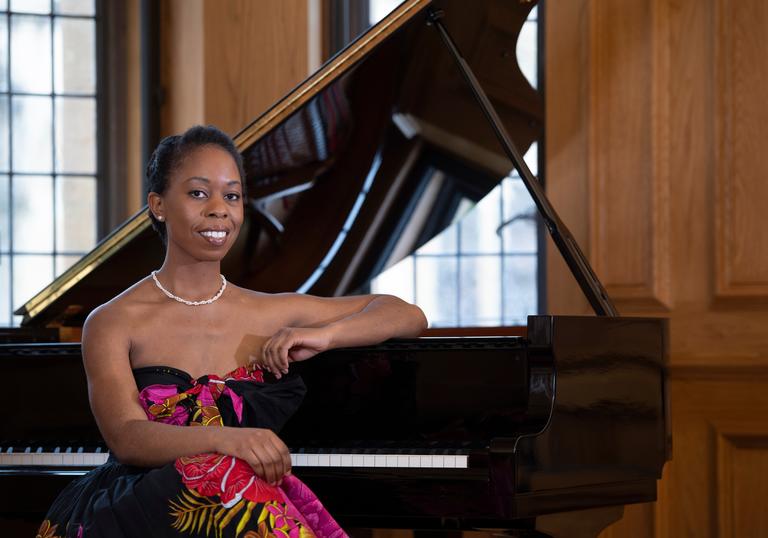 Samantha Ege sitting at a grand piano