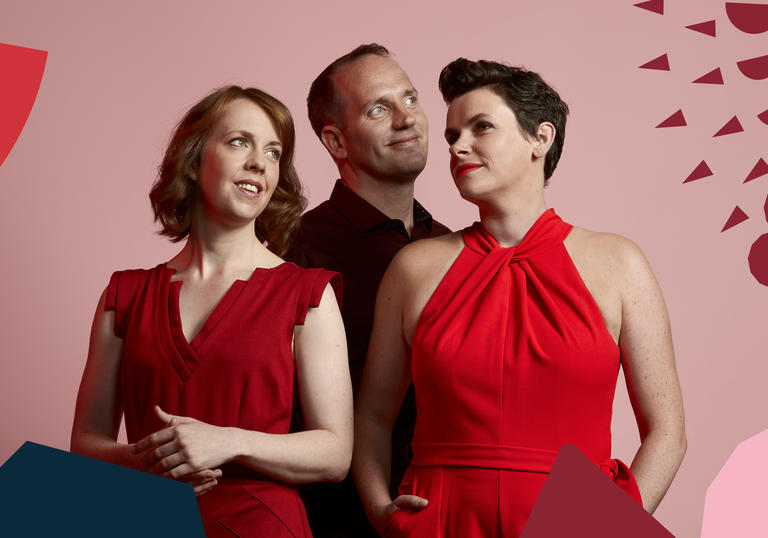 Nicholas Kok and two members of BBC Singers with BBC Singers branding around them
