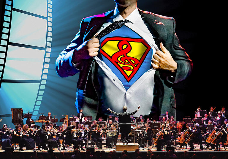 Superman's suit behind an orchestra on a stage