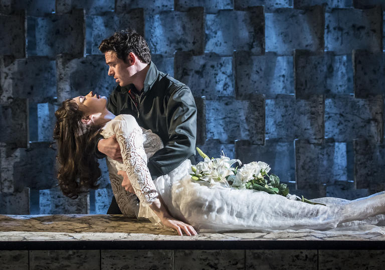 Richard Madden as Romeo holds Lily James as Juliet