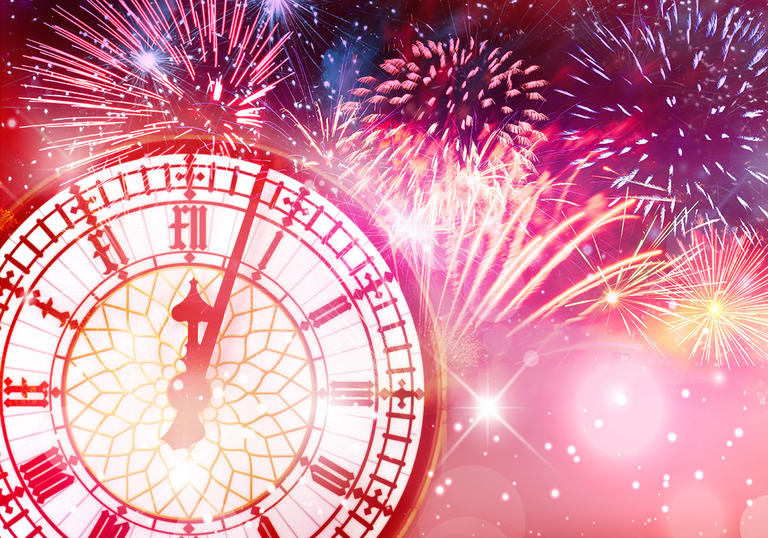 Big Ben's clock with fireworks behind