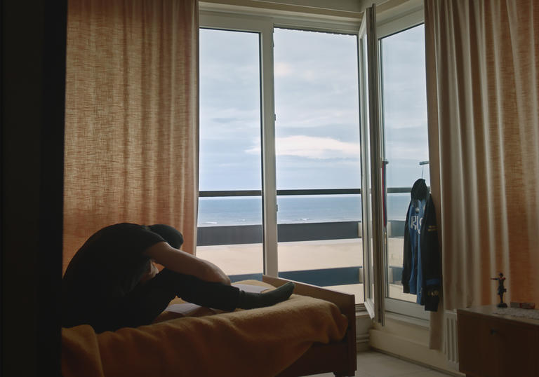 A man sits on a bed