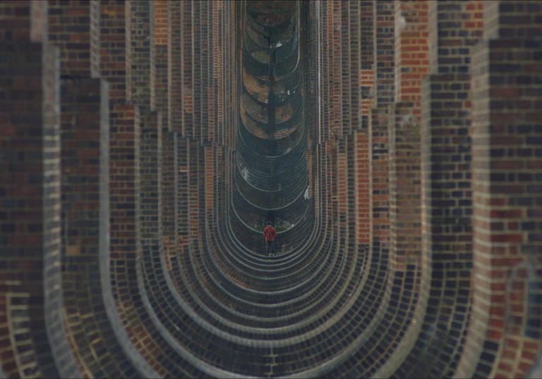 a boy in the background surrounded by brick circles