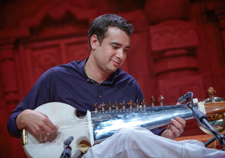 Colour photo of Alam Khan playing a sarod