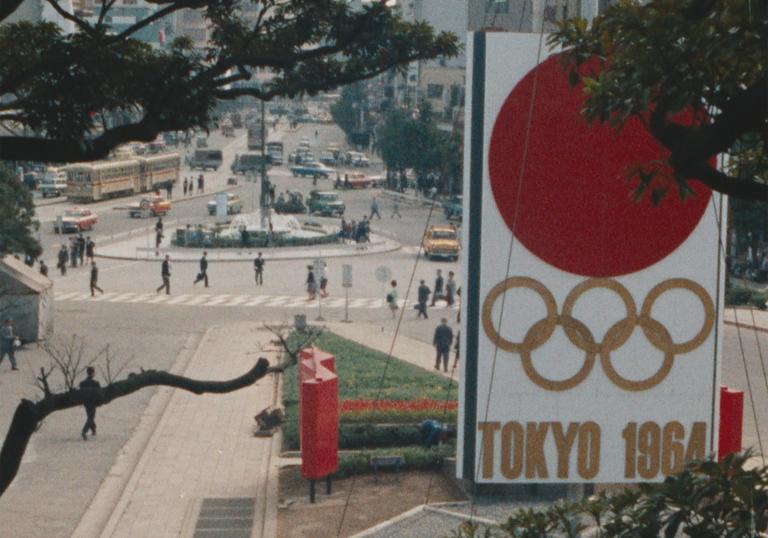 the streets of Tokyo with a Tokyo 1964 sign