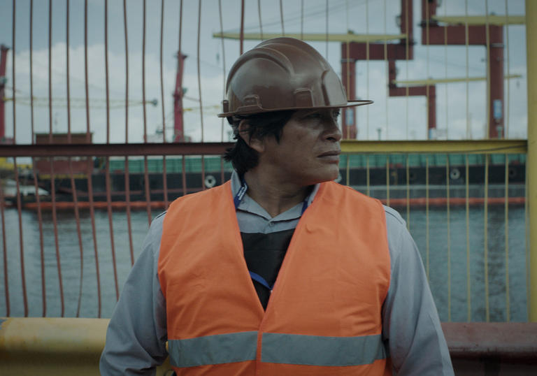 Man in protective wear standing on a building site