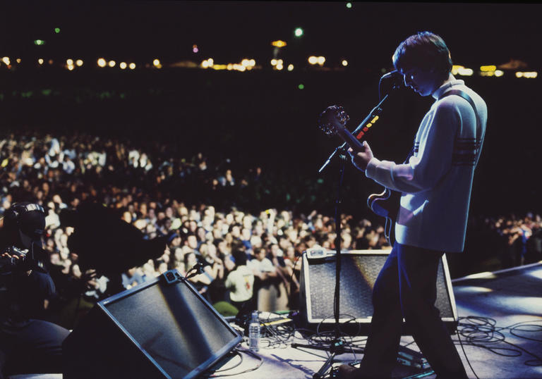 Oasis on stage at Knebworth looking out to the crowd