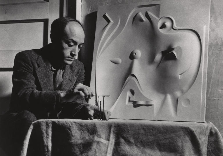 An image of Isamu Noguchi working in his studio 