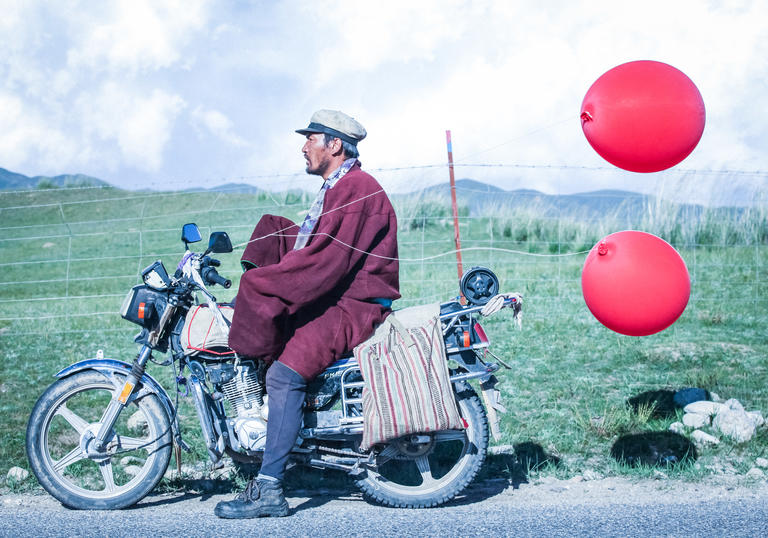 Man on motorbike with balloons