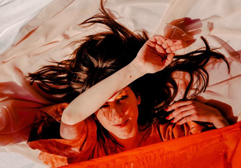 colour photo of Circuit des Yeux wrapped in orange sheets