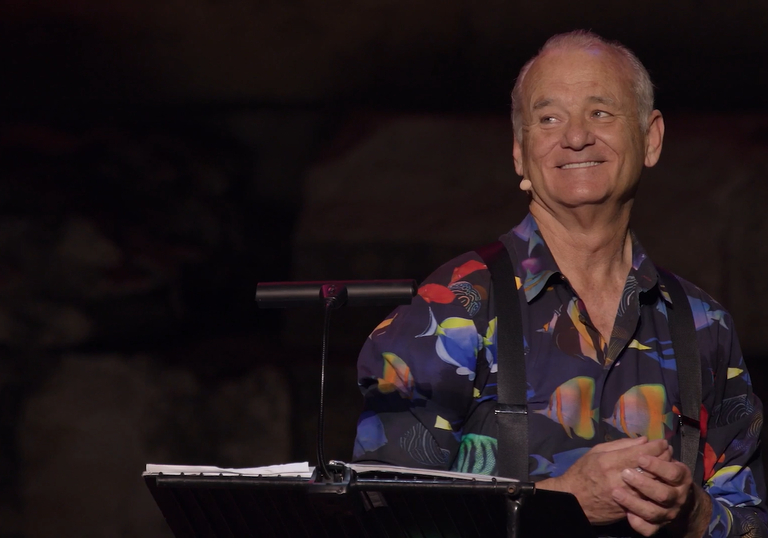 Bill Murray smiling on stage at the Acropolis