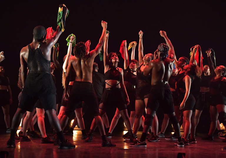 Dancers on stage with raised fists