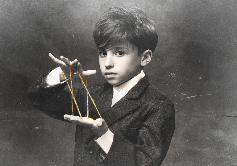 Black and white image of a young boy playing with string