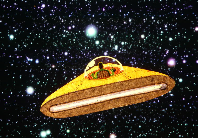 A yellow flying saucer in space