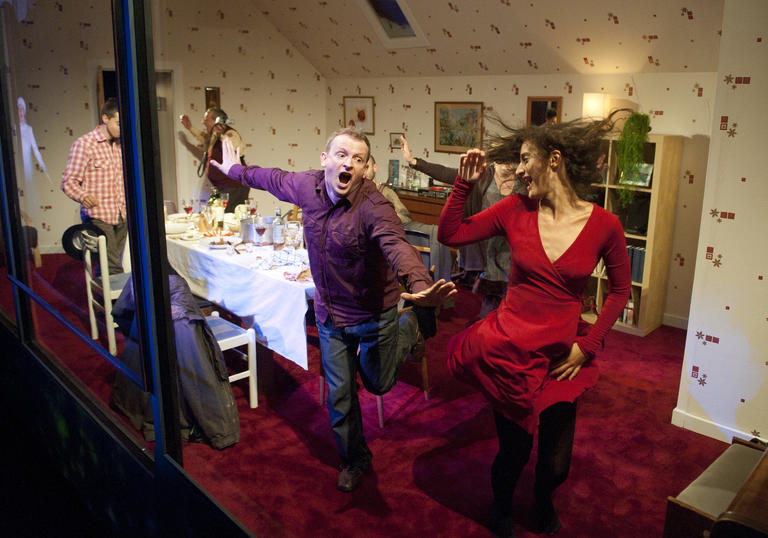 People dancing inside a living room set