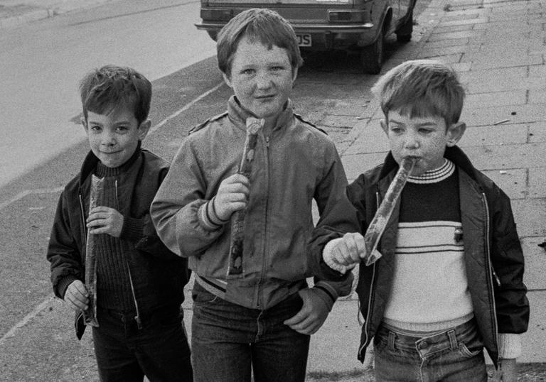 Three young boys looking at the camera