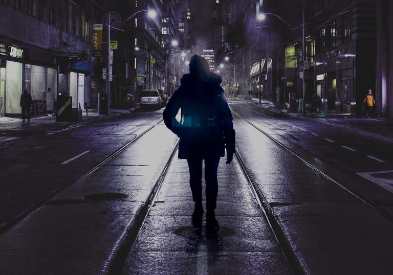 A young woman in the middle of a city street