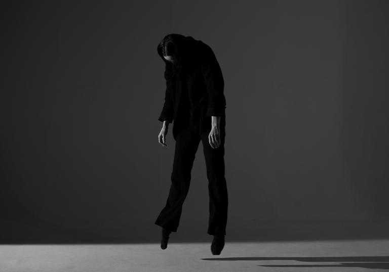 Keeley Forsyth levitating, wearing all black