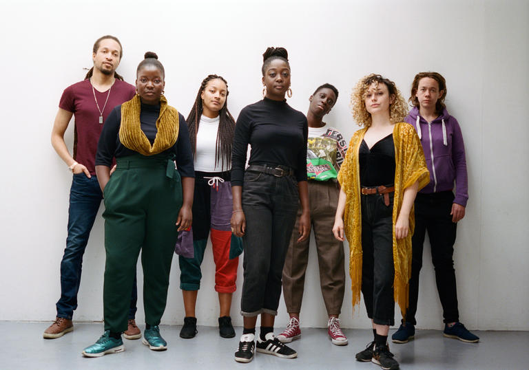 A group photo of Nerija wearing colourful clothes and looking at the camera