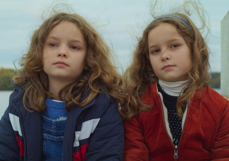 2 young girls sitting side by side